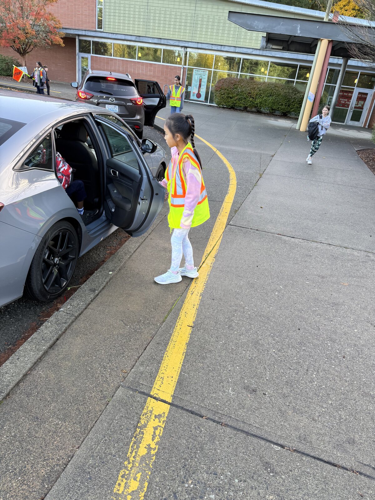 Sandra helping classmates as a safety patrol leader